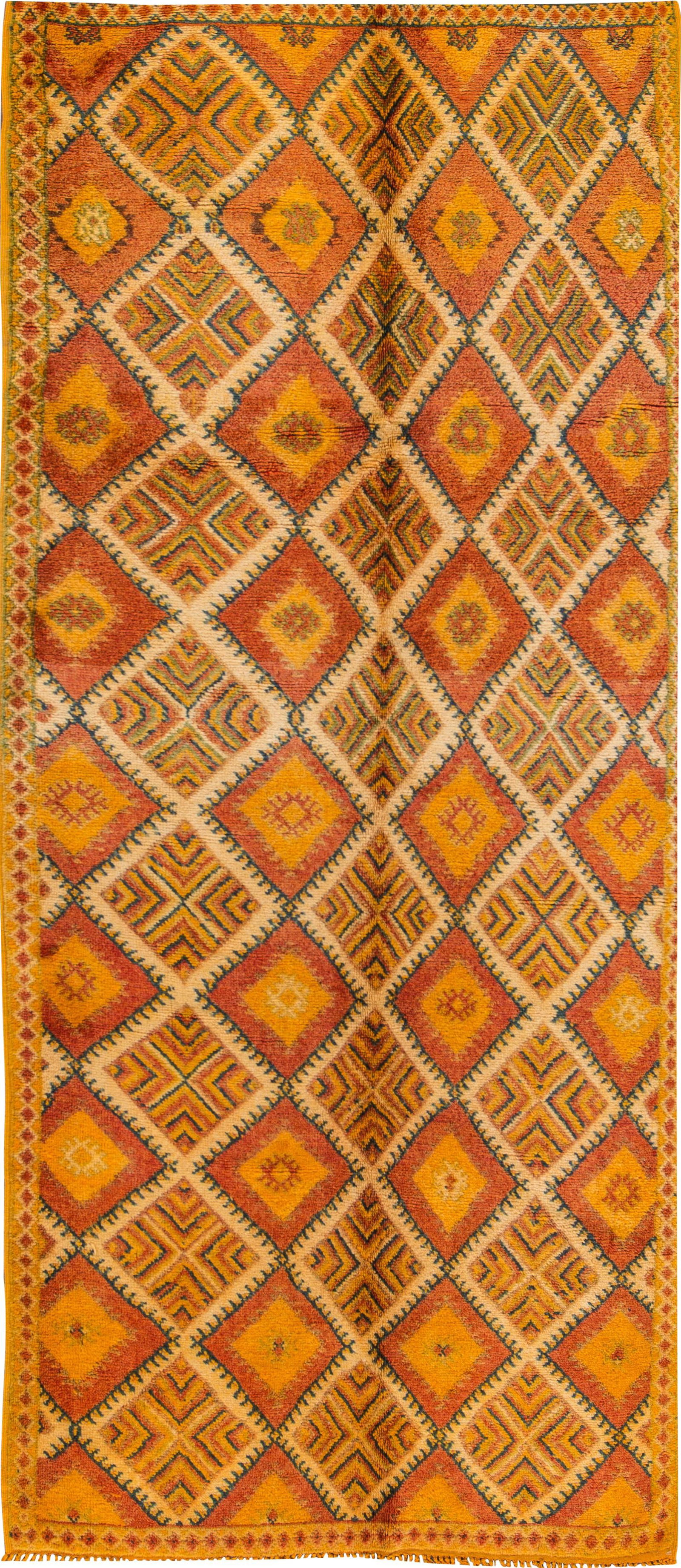 Mid-Century Vintage Orange Moroccan Tribal Wool Rug 5' x 11'6": Mid-Century Vintage Orange Moroccan Tribal Wool Rug 5' x 11'6" This stunning mid-20th century vintage Moroccan tribal wool rug features a captivating geometric interlocking diamond design in vibrant s