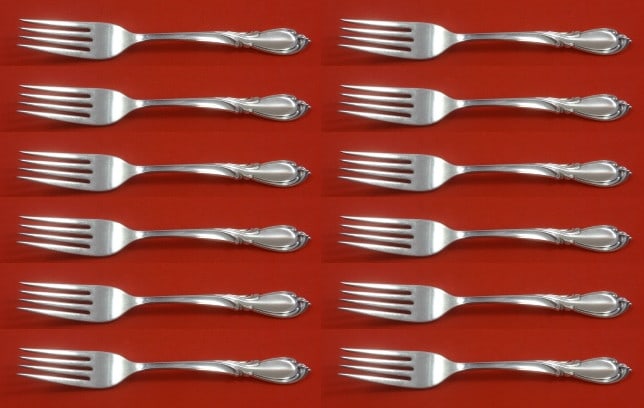 International Sterling Silver Rhapsody New Forks Set of 12 7 1/4": International Sterling Silver Rhapsody New Forks Set of 12 7 1/4" Enhance your dining experience with this exquisite set of 12 regular forks from the Rhapsody New pattern by International. Crafted fro