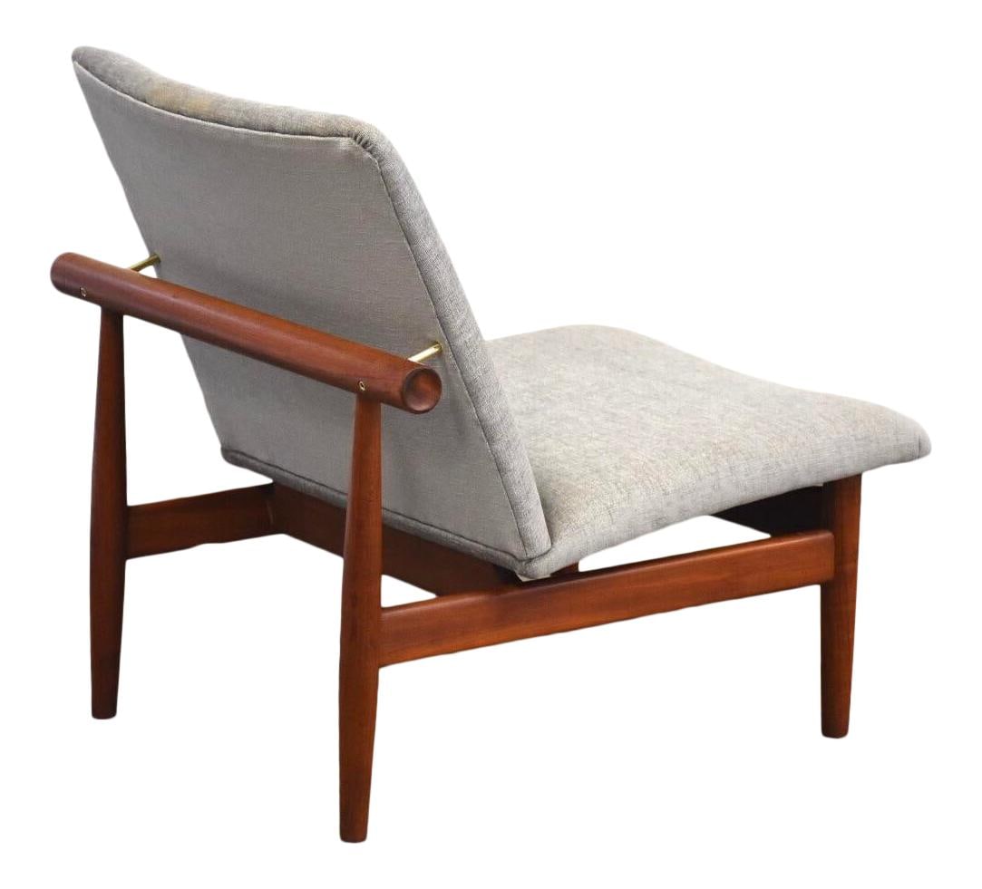 Finn Juhl Japan Teak Lounge Chair with Grey Upholstery: Finn Juhl Japan Teak Lounge Chair with Grey Upholstery Experience the elegance of mid-century modern design with the Finn Juhl "Japan" lounge chair. This exquisite piece features a stunning grey uphol