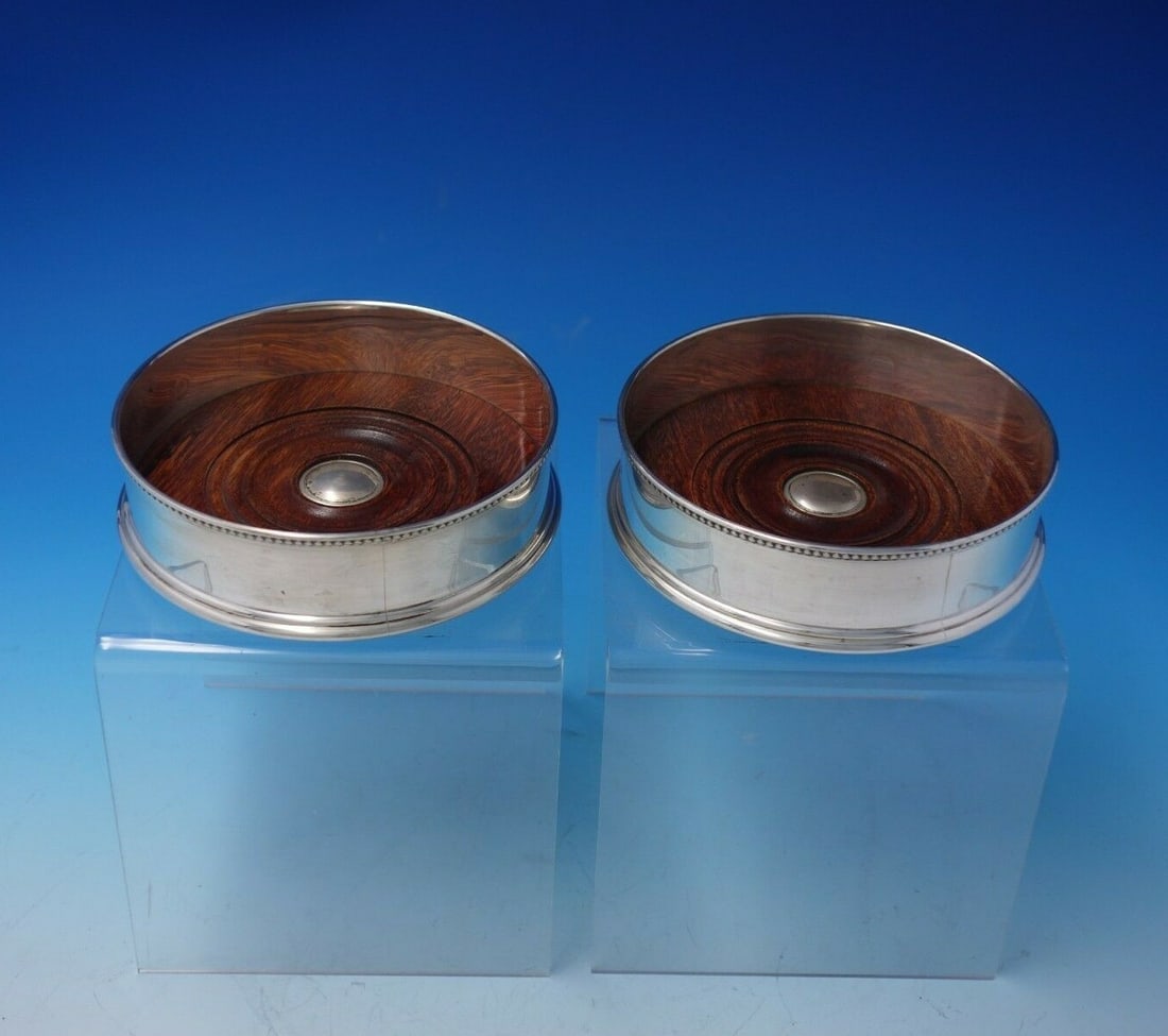 LB Limited Sterling Silver Beaded Coaster Pair with Maple Base: LB Limited Sterling Silver Beaded Coaster Pair with Maple Base This exquisite pair of coasters showcases the elegance of sterling silver craftsmanship by LB Limited of London. Each coaster features a