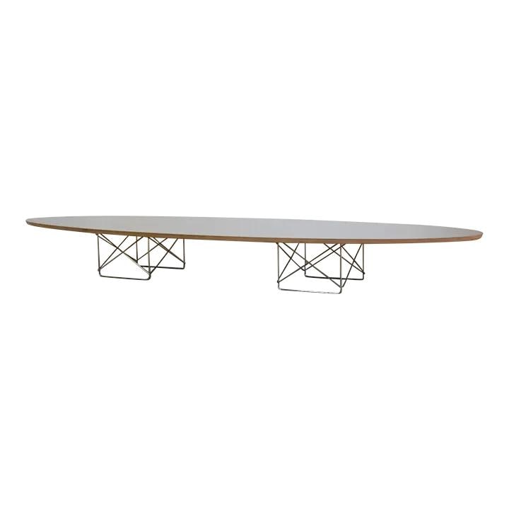 1990s Eames Oval Coffee Table by Herman Miller Black Chrome Base: 1990s Eames Oval Coffee Table by Herman Miller Black Chrome Base This elegant 1990s Eames oval coffee table showcases a sleek black design and is crafted with durable chrome wire bases. Designed by th
