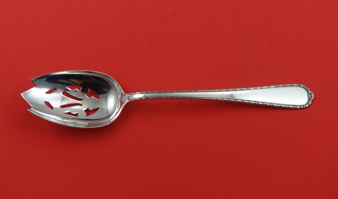 International Sterling Silver 8.5" Pine Tree Pierced Serving Spoon: International Sterling Silver 8.5" Pine Tree Pierced Serving Spoon This exquisite pierced serving spoon features the elegant Pine Tree pattern by International Sterling. Crafted from high-quality ster
