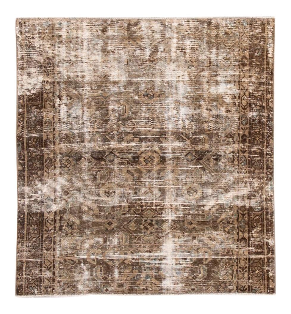 Early 20th Century Hand-Knotted Distressed Wool Square Rug: Early 20th Century Hand-Knotted Distressed Wool Square Rug This exquisite early 20th-century vintage distressed wool rug showcases a beautiful brown field adorned with subtle ivory accents. Hand-knott