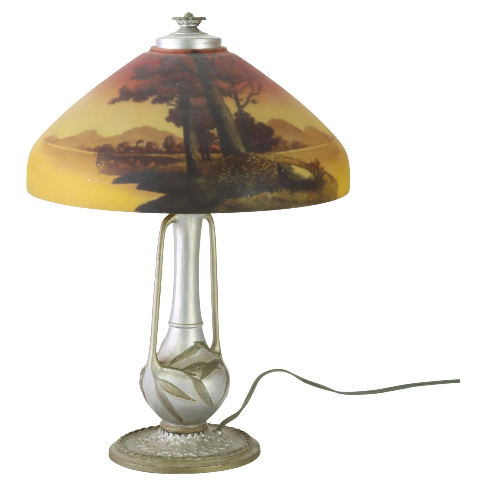 Reverse Painted Landscape Glass Table Lamp by Phoenix Circa 1920: Reverse Painted Landscape Glass Table Lamp by Phoenix Circa 1920 This antique table lamp from circa 1920 features a reverse-painted glass shade with a detailed landscape scene. The base is intricately