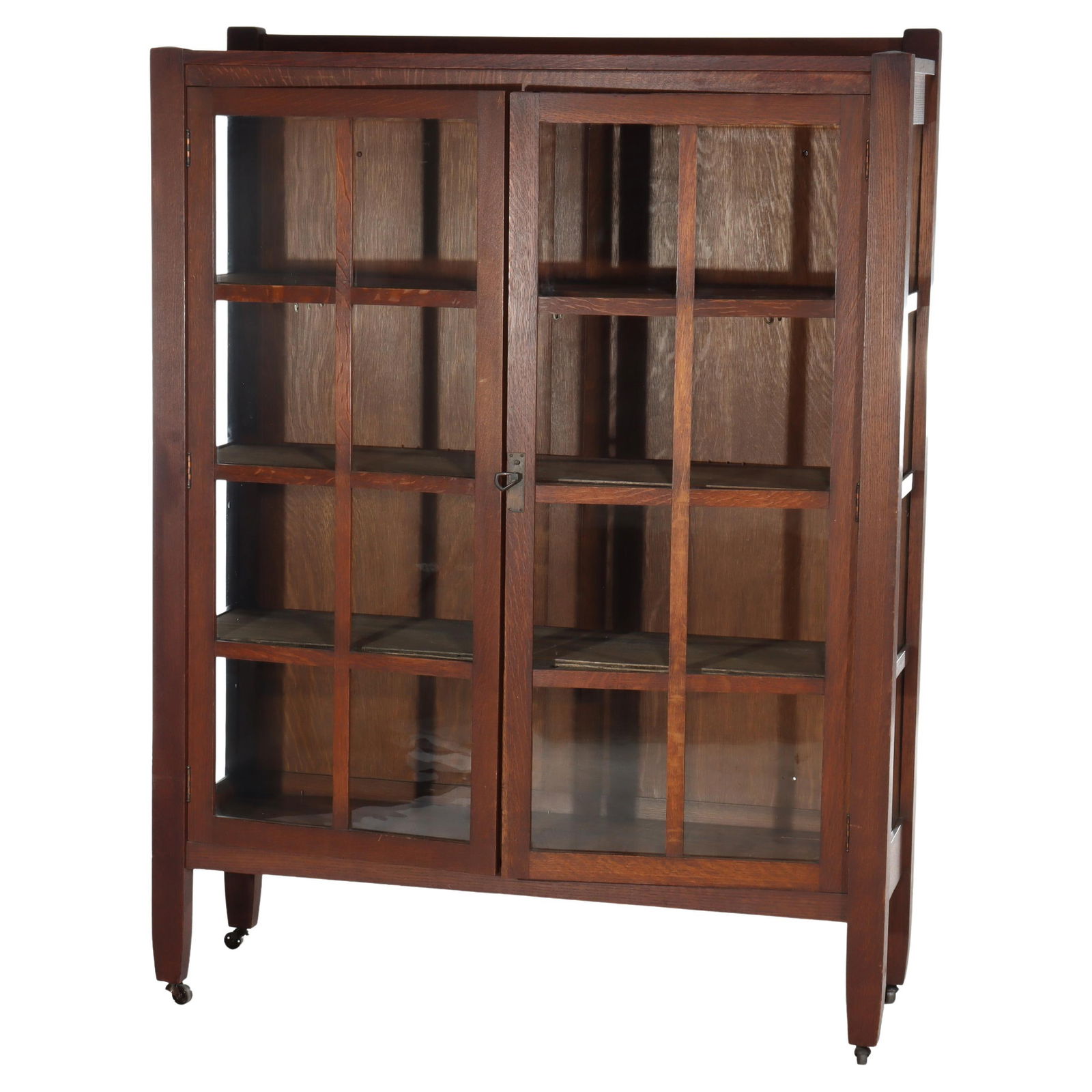 Oak Mission Style Double Door Bookcase in the Manner of Stickley Circa 1920: Oak Mission Style Double Door Bookcase in the Manner of Stickley Circa 1920 This antique Arts and Crafts Mission oak bookcase, crafted circa 1920 in the manner of Stickley, features a classic mission