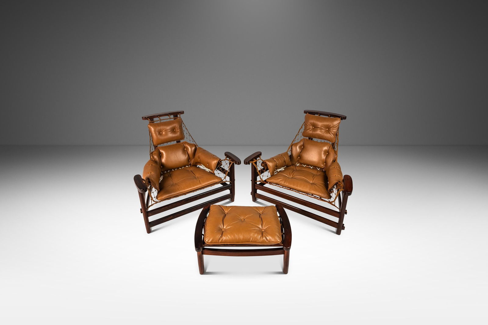 Rare Jean Gillon Jangada Lounge Chair Set with Ottoman in Jacaranda Leather: Rare Jean Gillon Jangada Lounge Chair Set with Ottoman in Jacaranda Leather Introducing a rare set of two 'Jangada' lounge chairs with a matching ottoman, designed by the renowned Jean Gillon for Wood