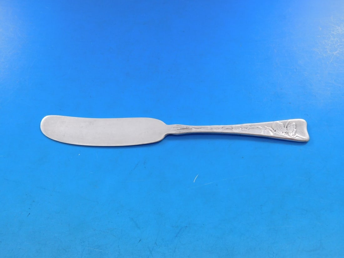 Tiffany & Co Sterling Silver 6" Plum Blossom Butter Spreader Acid Etched: Tiffany & Co Sterling Silver 6" Plum Blossom Butter Spreader Acid Etched This exquisite butter spreader by Tiffany & Co. showcases the elegant Lap Over Edge Acid Etched pattern, featuring a beautiful