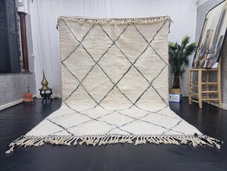 Handmade White Wool Rug Black Geometric Pattern 8 x 5 Feet Morocco: Handmade White Wool Rug Black Geometric Pattern 8 x 5 Feet Morocco Enhance your space with this authentic soft white handmade wool rug featuring a striking black geometric engraved pattern. This exqui