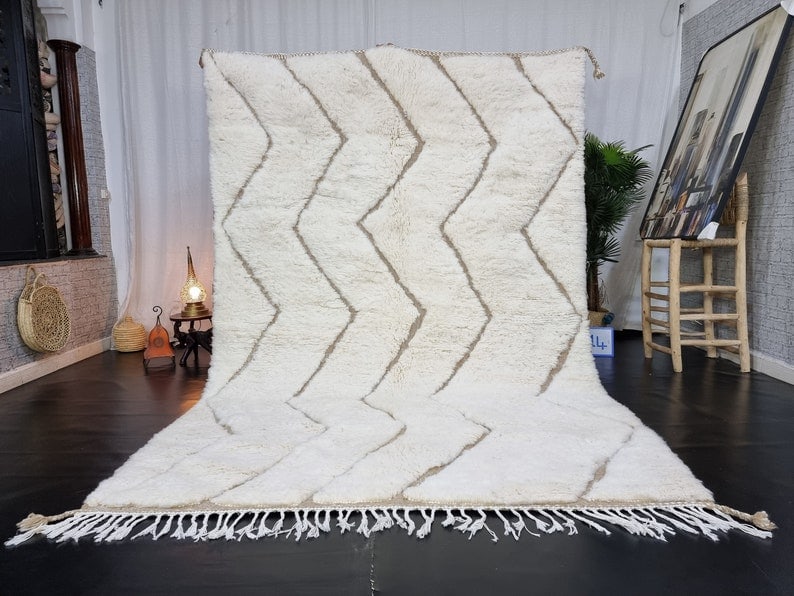 Handwoven White Soft Engraved Wool Rug from Morocco: Handwoven White Soft Engraved Wool Rug from Morocco Introducing the Authentic White Soft Engraved Rug, a beautifully handwoven piece crafted by local Berber women weavers in the Atlas Mountains. This