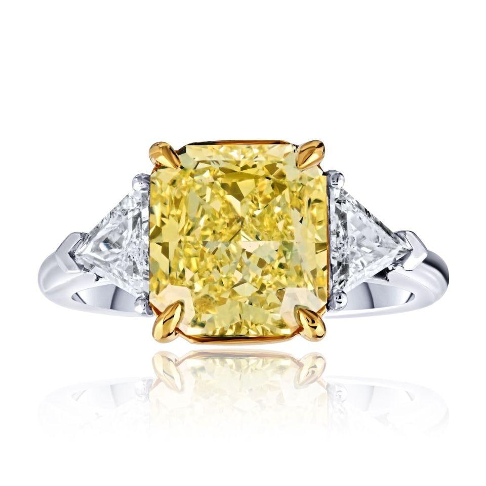 3.56 Carat Fancy Yellow Radiant Cut Diamond Ring Platinum 18K Yellow Gold: 3.56 Carat Fancy Yellow Radiant Cut Diamond Ring Platinum 18K Yellow Gold This exquisite ring features a stunning 3.56 carat radiant cut diamond in a fancy yellow hue, complemented by trillion cut sid