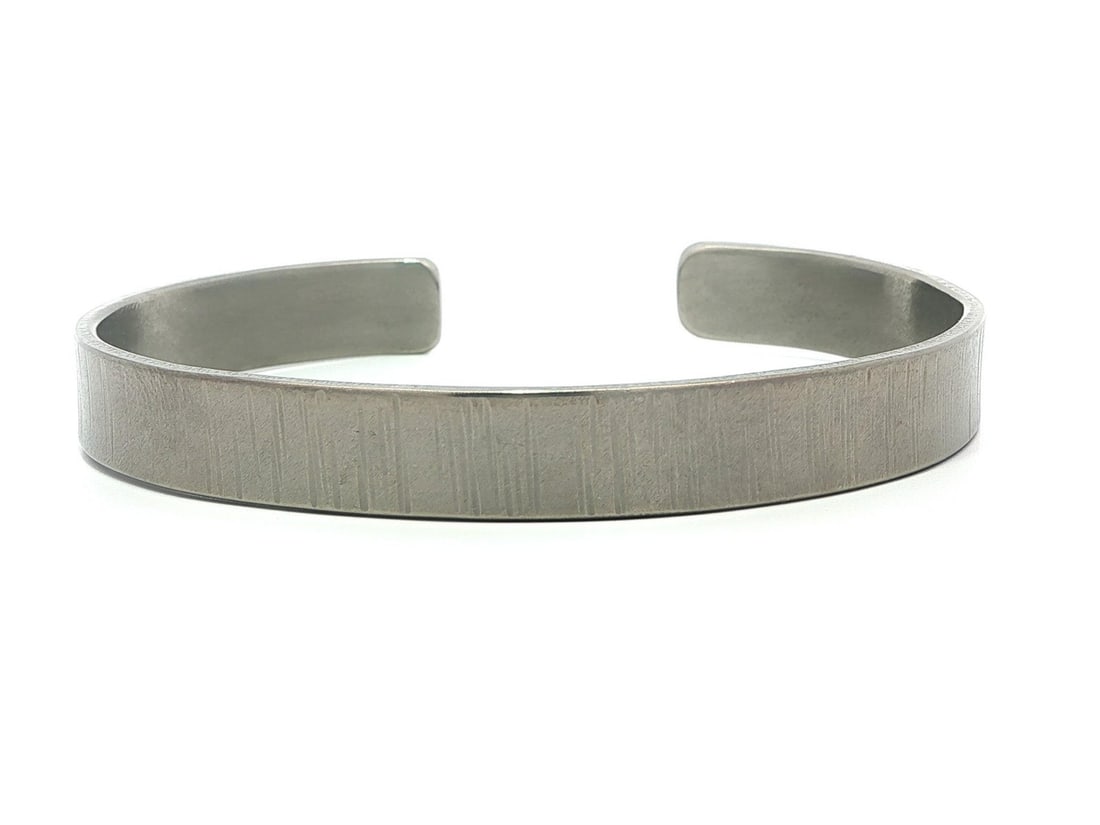 Etched Titanium Plated Matte Open Cuff Bracelet 6.25 Inch: Etched Titanium Plated Matte Open Cuff Bracelet 6.25 Inch This open cuff bracelet features a detailed etched design with a matte finish, crafted from titanium. It is designed to comfortably fit wrists