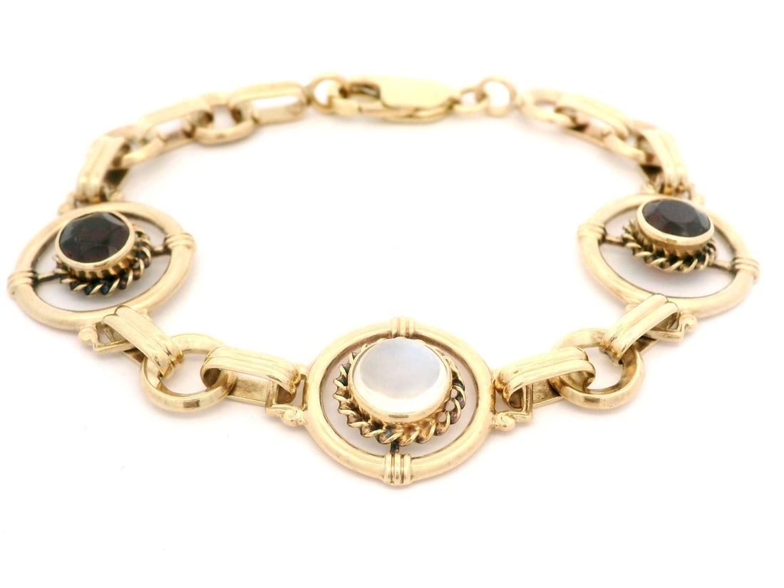 Antique Victorian 9k Gold Garnet Moonstone Circle Link Bracelet: Antique Victorian 9k Gold Garnet Moonstone Circle Link Bracelet This exquisite Antique Victorian bracelet showcases a beautiful combination of garnets and moonstone set in solid 9k yellow gold. The pi