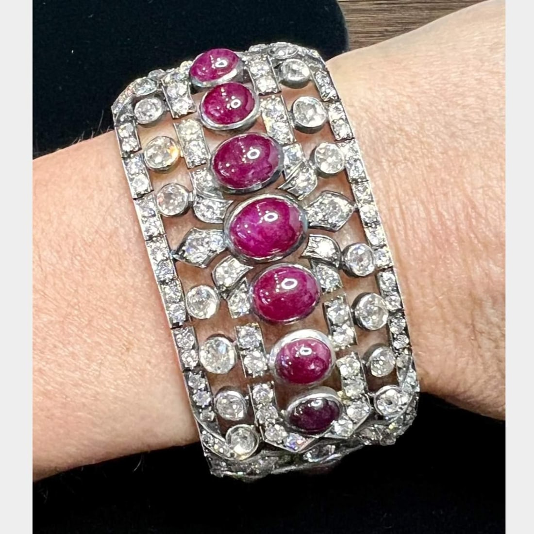 Art Deco Platinum Bracelet with 17 Rubies and 285 Diamonds: Art Deco Platinum Bracelet with 17 Rubies and 285 Diamonds This exquisite Art Deco bracelet showcases a stunning arrangement of 17 cabochon rubies, with a total weight of approximately 30.00 ct. Compl