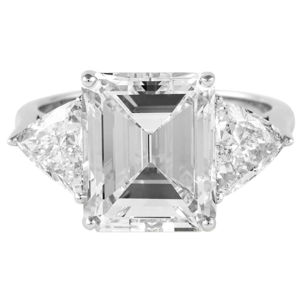 5.20ct Emerald Cut Diamond GIA Certified Three-Stone Ring in 18k White Gold: 5.20ct Emerald Cut Diamond GIA Certified Three-Stone Ring in 18k White Gold This exquisite three-stone engagement ring features a stunning 5.20 carat emerald cut diamond at its center. The diamond is