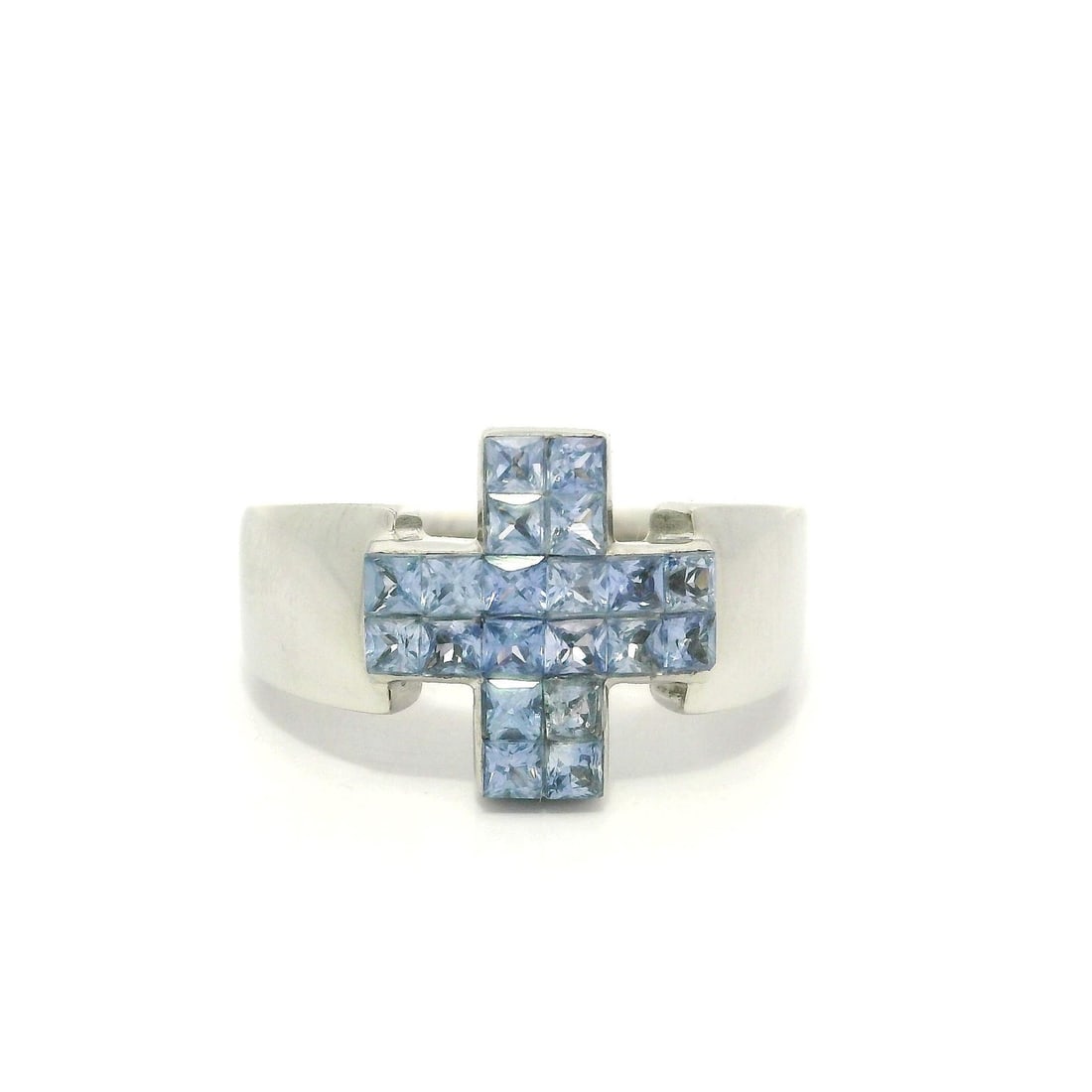 18k White Gold 0.80ct Cornflower Sapphire Cross Band Ring: 18k White Gold 0.80ct Cornflower Sapphire Cross Band Ring This unique band ring features a stunning arrangement of natural genuine sapphires in a square French cut, totaling approximately 0.80 carats.