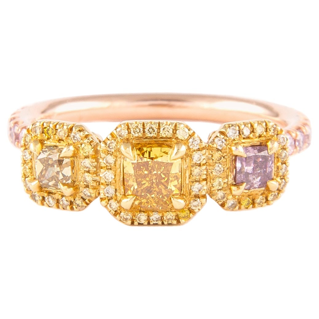 1.05ct Fancy Color Diamond Halo Ring: 1.05ct Fancy Color Diamond Halo Ring This stunning three-stone halo ring features a total diamond weight of 1.05 carats, showcasing a captivating combination of fancy yellow and pink diamonds. The rin