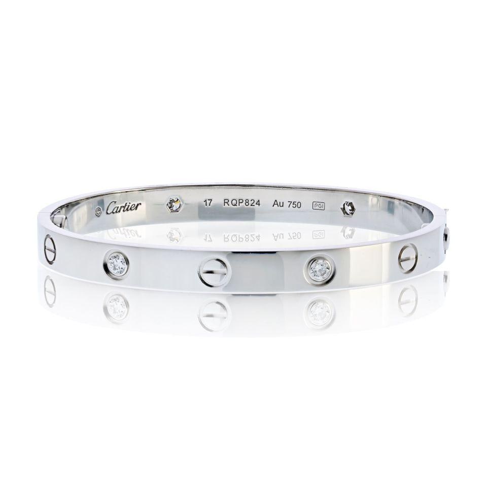 Cartier Love Bracelet 18K White Gold 4 Diamonds Size 17 with Box & Papers: Cartier Love Bracelet 18K White Gold 4 Diamonds Size 17 with Box & Papers This exquisite pre-owned Cartier Love bracelet is crafted from 18K white gold, weighing 31.9 grams and sized at 17. It feature