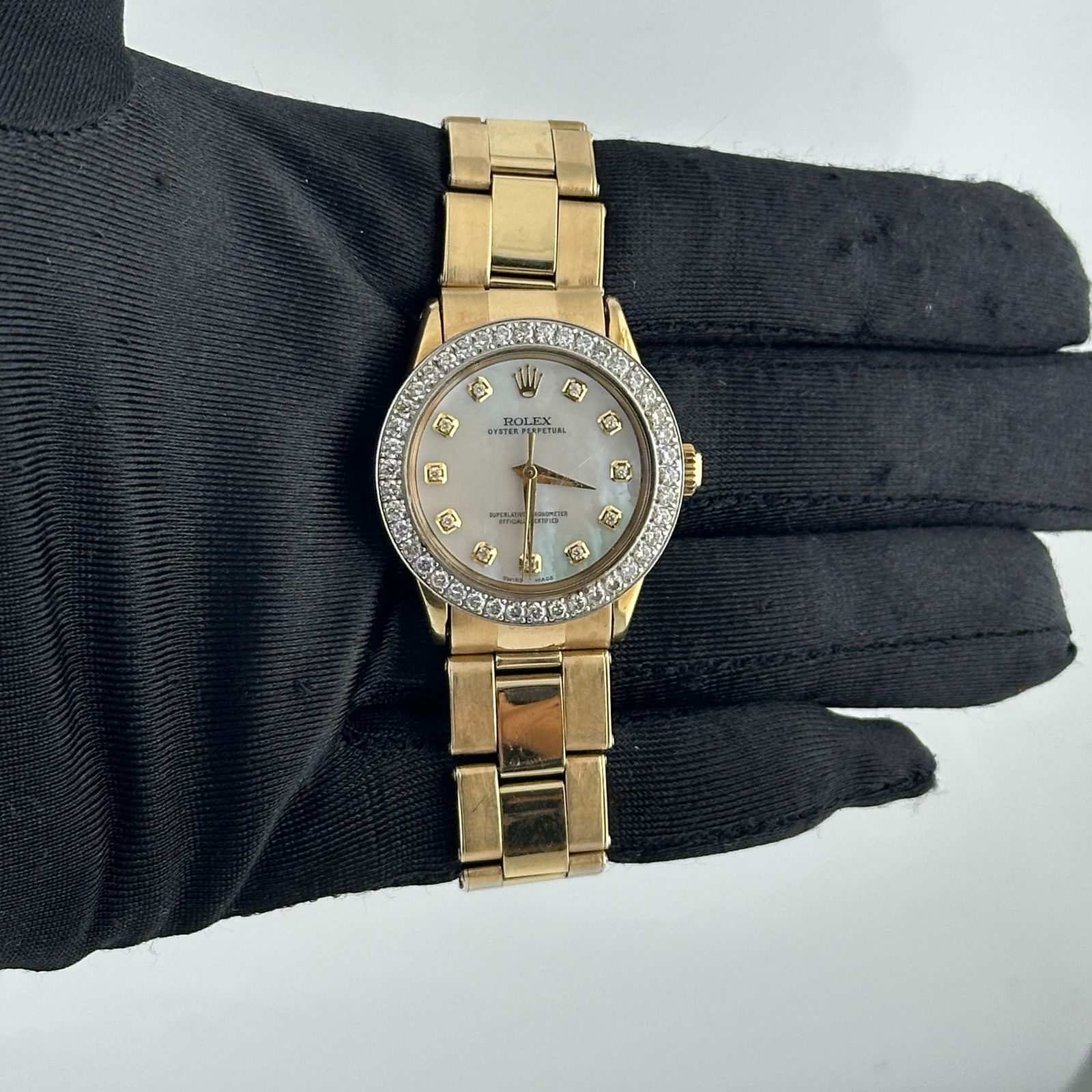 Oyster Perpetual Ref 6548 White MOP Diamond Dial on 14k Oyster Bracelet: Oyster Perpetual Ref 6548 White MOP Diamond Dial on 14k Oyster Bracelet This Rolex Oyster Perpetual watch features an aftermarket white mother-of-pearl diamond dial, a pave diamond stainless steel bez
