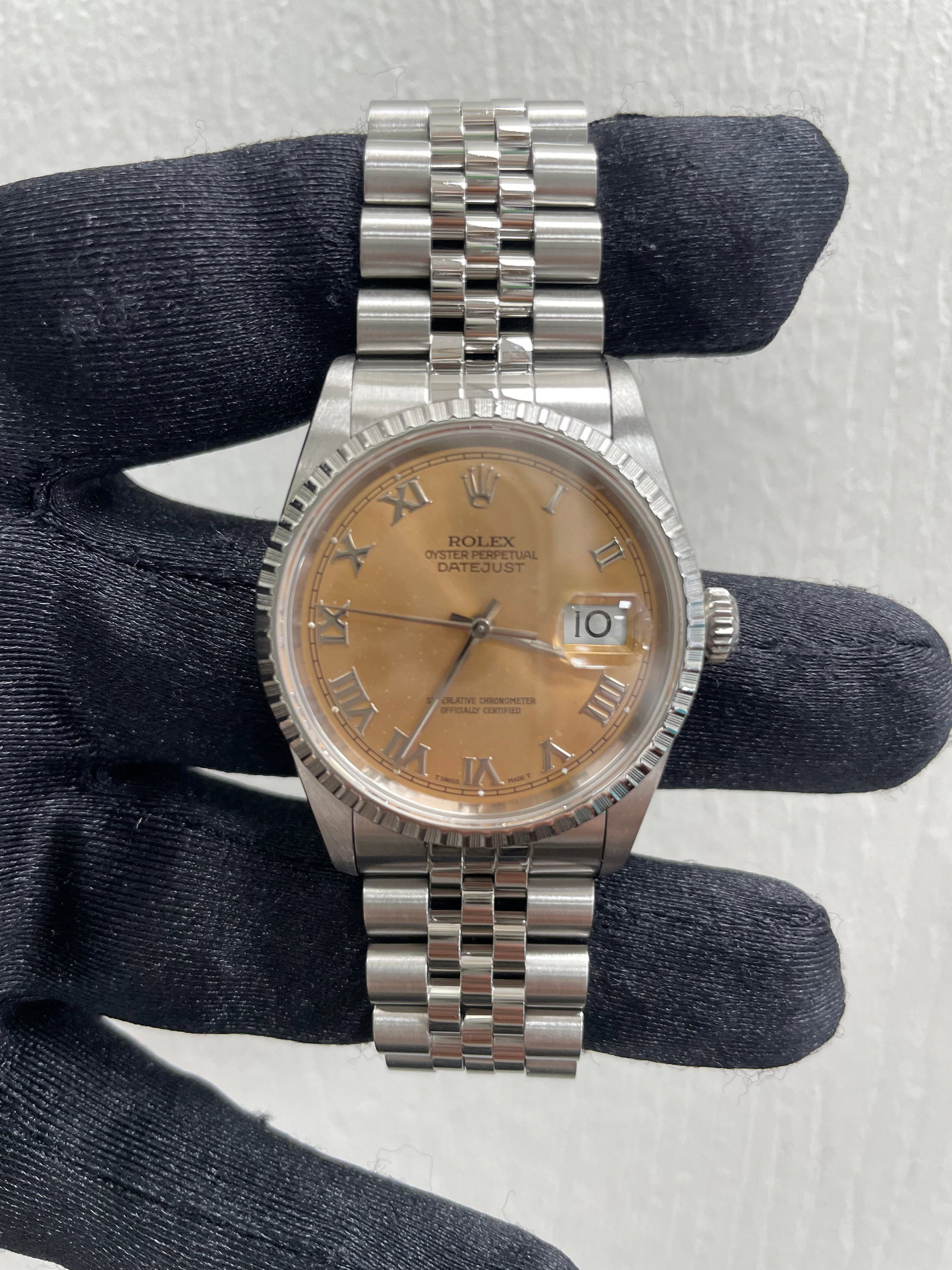 Datejust 16220 Men's Watch Copper Dial Jubilee Bracelet: Datejust 16220 Men's Watch Copper Dial Jubilee Bracelet This Rolex Datejust features a copper dial and is paired with a Jubilee bracelet. The watch includes an engine-turned bezel and is designed for