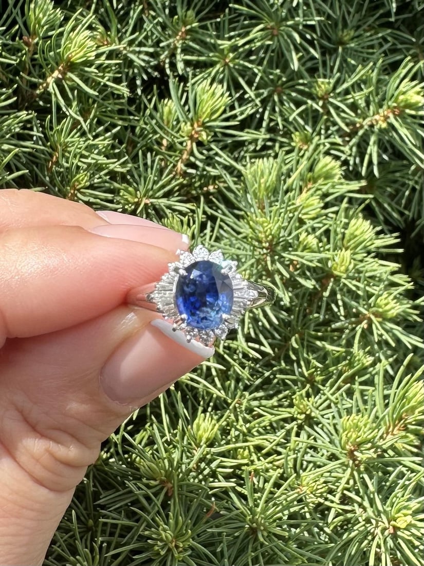 GIA Certified 2.4ctw Oval Royal Blue Sapphire Platinum Ring with Diamond Halo: GIA Certified 2.4ctw Oval Royal Blue Sapphire Platinum Ring with Diamond Halo This exquisite cocktail ring features a stunning natural oval brilliant cut royal blue sapphire, weighing 2.02ct, set in s