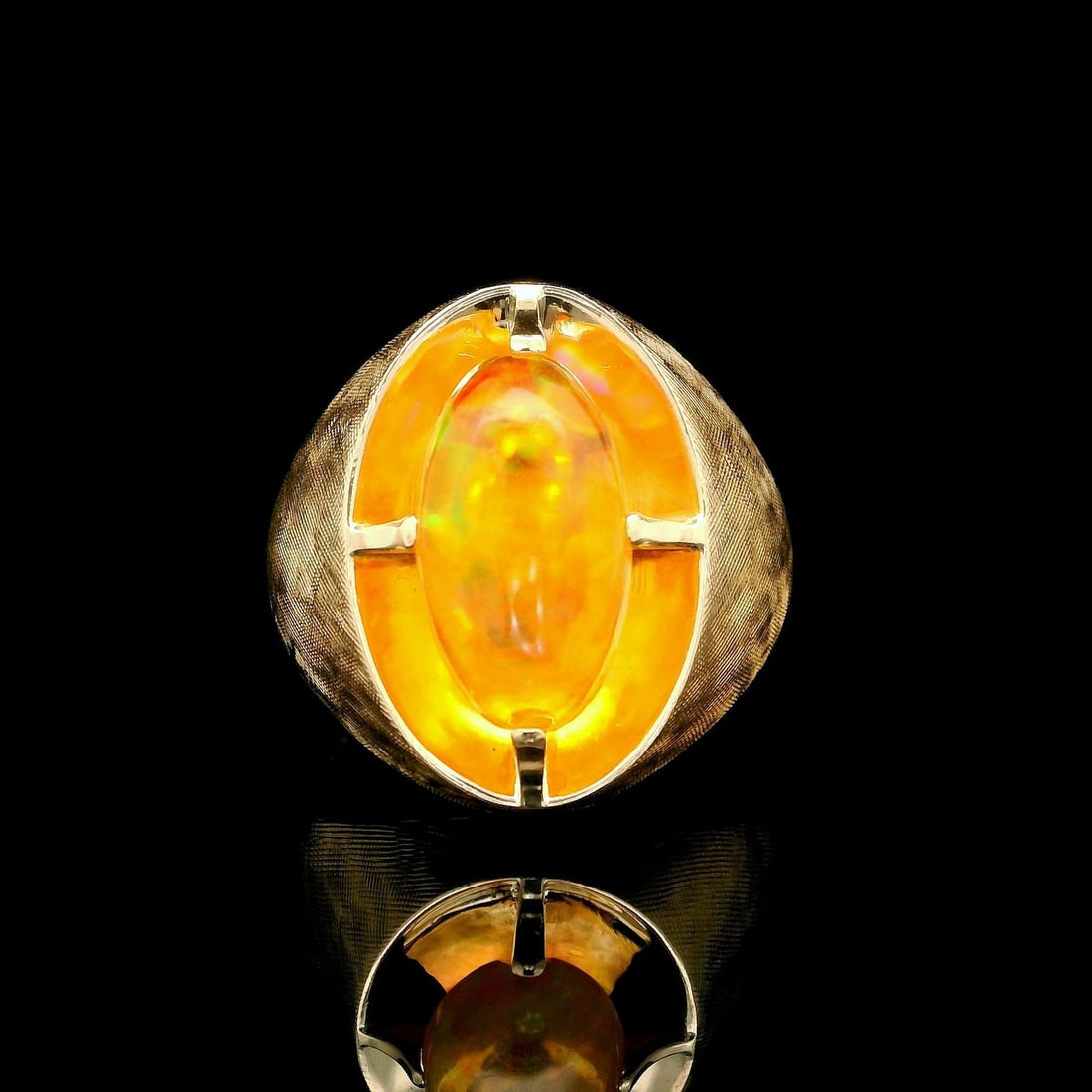 14k Yellow Gold Oval Orange Jelly Opal Statement Ring: 14k Yellow Gold Oval Orange Jelly Opal Statement Ring Make a bold statement with this exquisite 14k Yellow Gold Oval Orange Jelly Opal Ring. The centerpiece is a stunning natural jelly opal, featuring