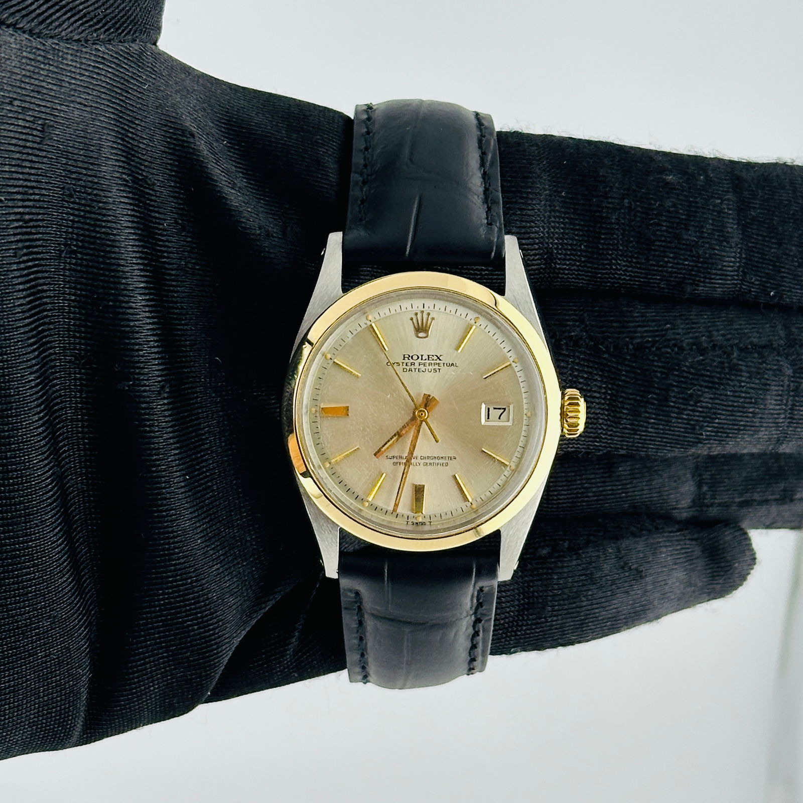 Men's Datejust Ref 1600 Silver Gold Stick Dial on Aftermarket Leather: Men's Datejust Ref 1600 Silver Gold Stick Dial on Aftermarket Leather This is a men's Rolex Datejust watch, reference 1600, featuring a silver and gold stick dial with a smooth bezel. The watch is fit