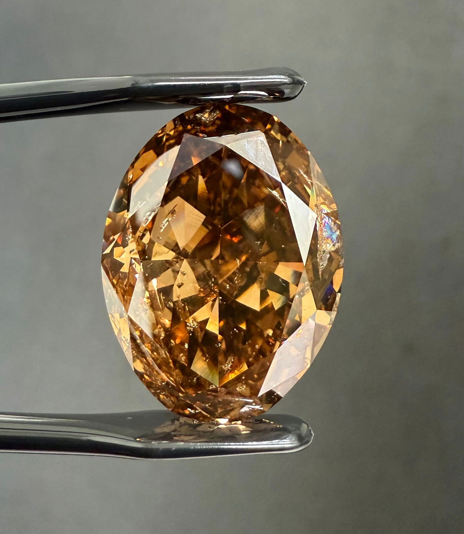 Loose Diamond - OVAL 24.56ct Fancy Dark Orangey Brown: Loose Diamond - OVAL 24.56ct Fancy Dark Orangey Brown Source: Natural Shape: OVAL Carats: 24.56 Color: Fancy Dark Orangey Brown Certification: GIA PLEASE NOTE: Framed, Large, or heavy items do not hav