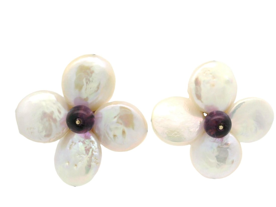 14k Yellow Gold Convertible Flower Earrings with Coin Pearls and Amethyst: 14k Yellow Gold Convertible Flower Earrings with Coin Pearls and Amethyst Elevate your accessory collection with these stunning convertible back earrings, crafted from 14k yellow gold. These earrings