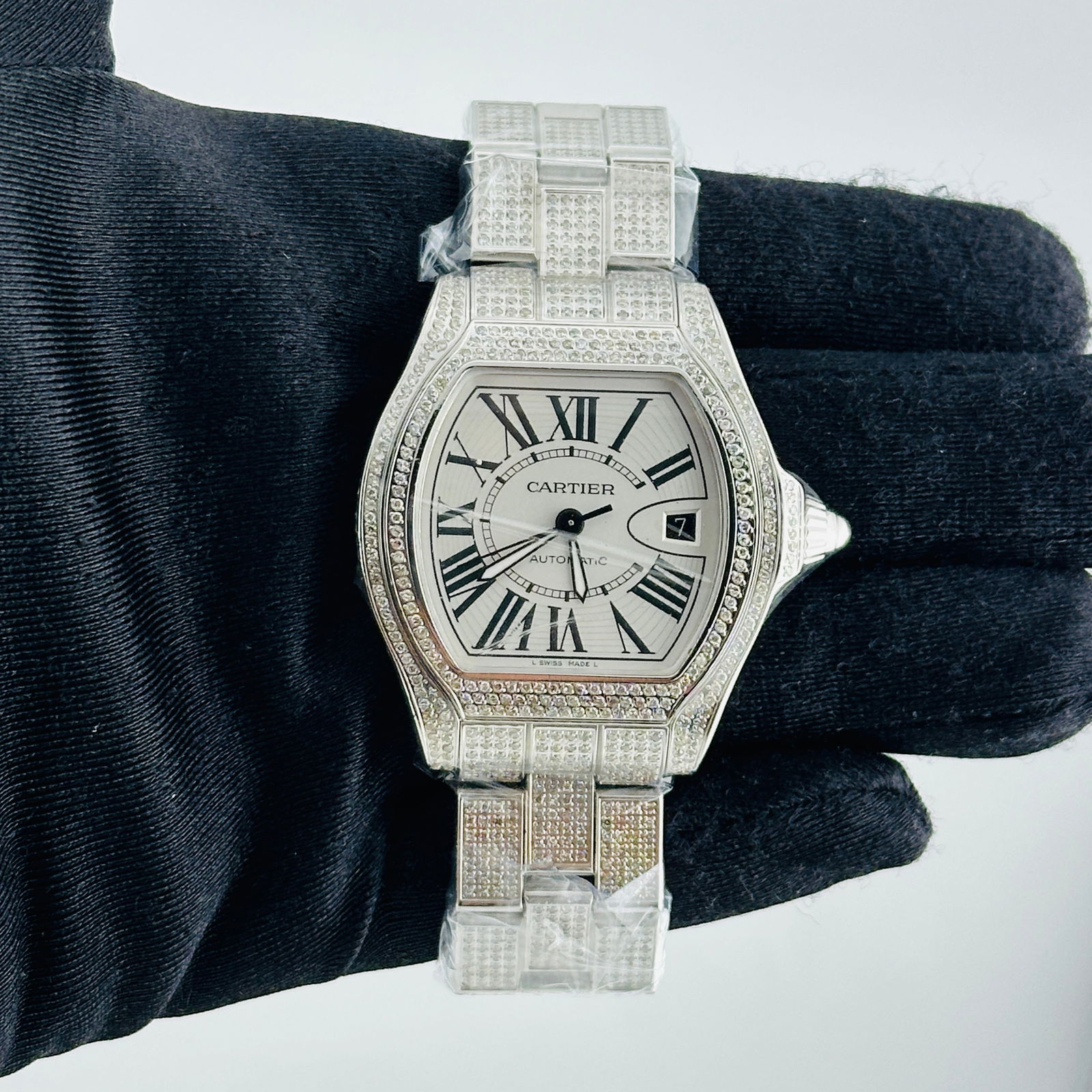 Diamond Accented Cartier Roadster Silver Roman Dial Watch Ref 3312: Diamond Accented Cartier Roadster Silver Roman Dial Watch Ref 3312 This Cartier Roadster watch features a silver Roman numeral dial, complemented by a diamond-set bezel and bracelet. Designed for men,