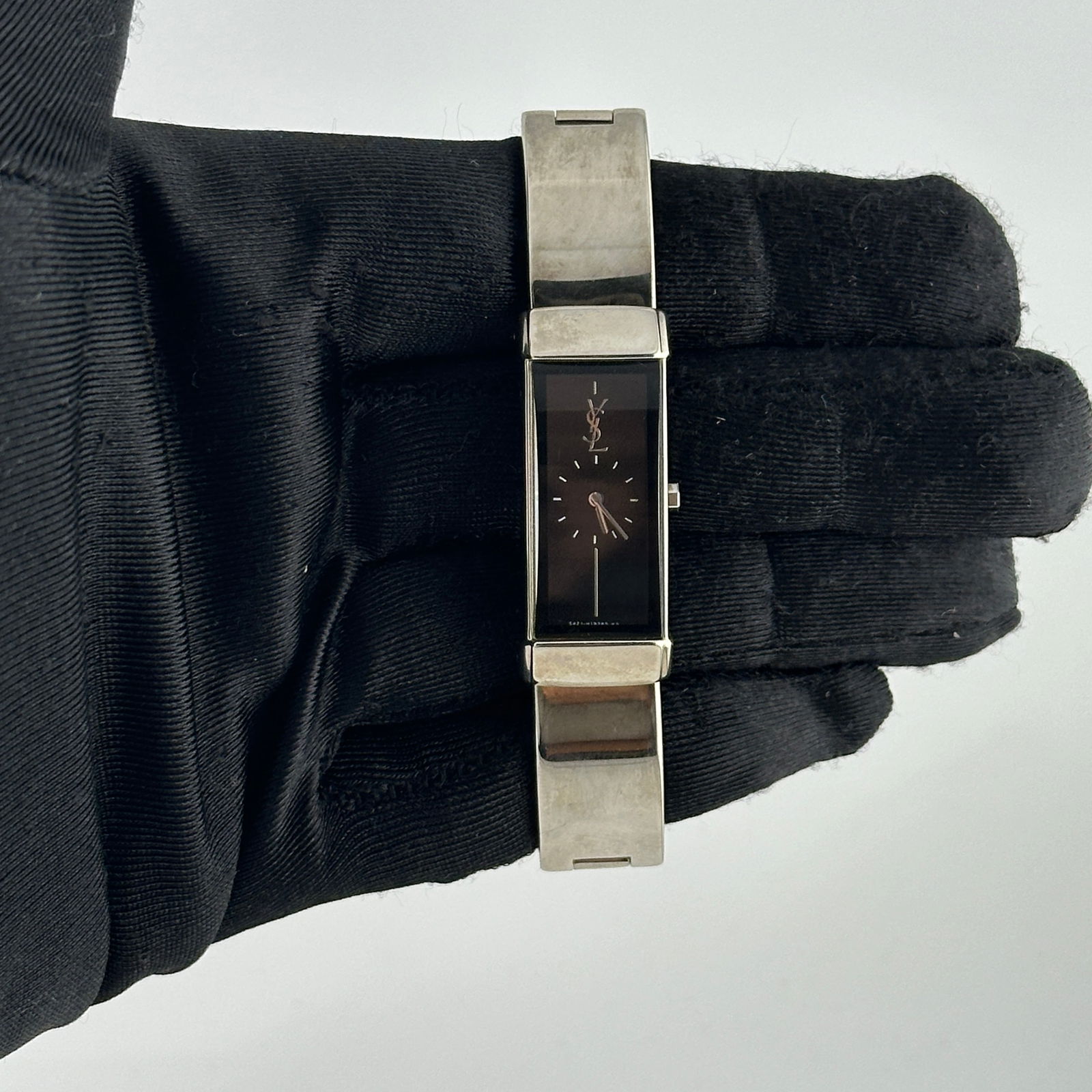 Black Dial 15mm Stainless Steel Watch Yves Saint Laurent Ref 5421H05569Y: Black Dial 15mm Stainless Steel Watch Yves Saint Laurent Ref 5421H05569Y This Yves Saint Laurent watch features a black dial and stainless steel construction. The watch measures 15mm and is in very go