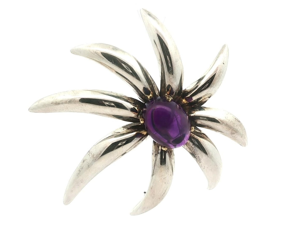 Tiffany & Co. 18k Yellow Gold Amethyst Fireworks Brooch Pin: Tiffany & Co. 18k Yellow Gold Amethyst Fireworks Brooch Pin This stunning Tiffany & Co. brooch features a large cabochon amethyst set against a backdrop of 18k yellow gold and sterling silver. The nat