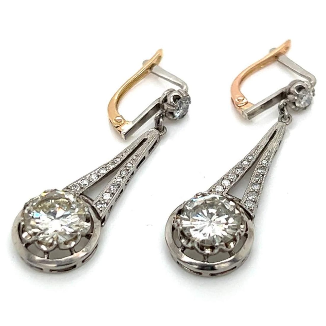 Art Deco Platinum 3.45 Ct. Diamond Earrings Vintage Elegance: Art Deco Platinum 3.45 Ct. Diamond Earrings Vintage Elegance These exquisite Art Deco earrings are crafted in platinum and feature a total diamond weight of 3.45 carats. The stunning design showcases