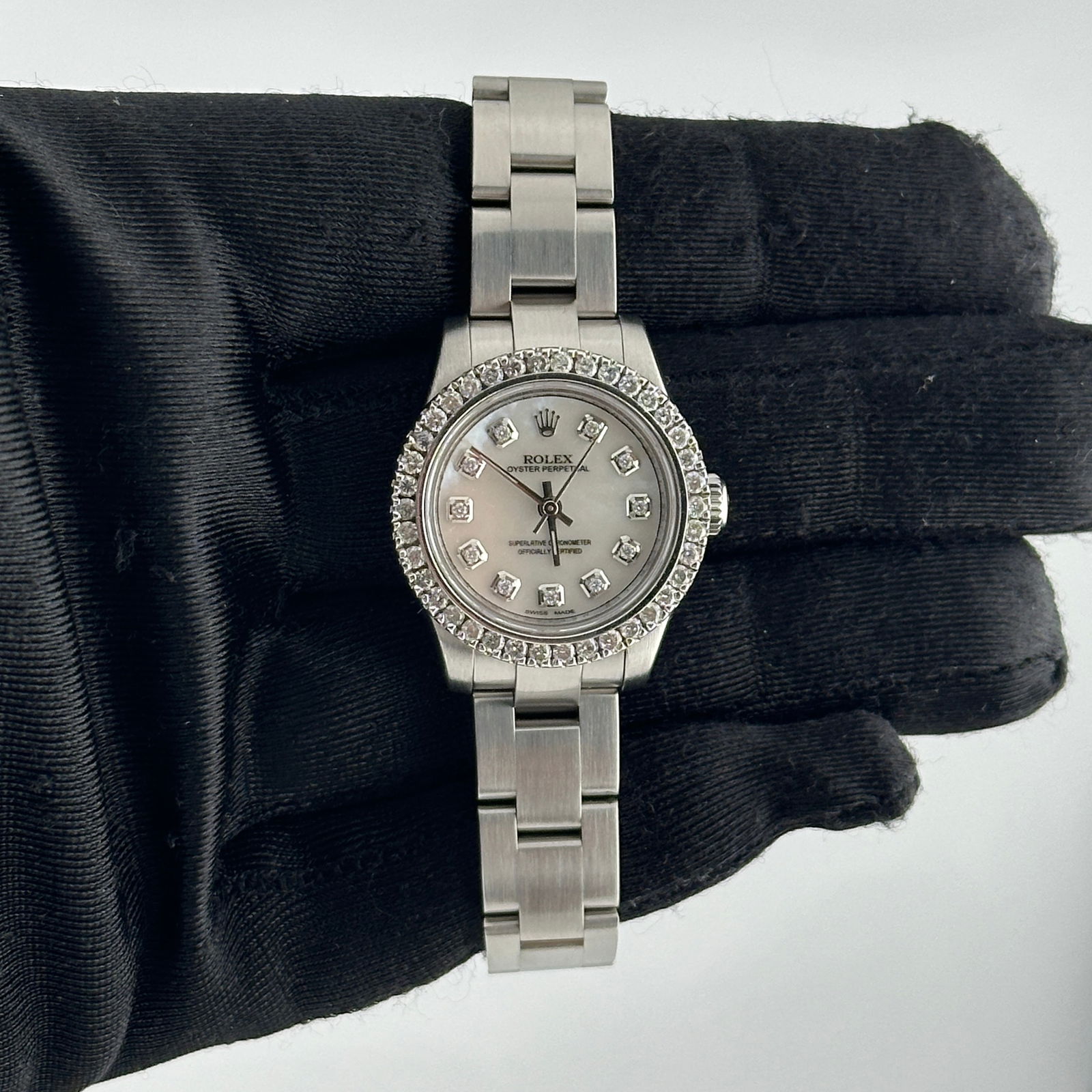 Ladies Rolex 176200 Oyster Perpetual Aftermarket White MOP Diamond Dial Watch: Ladies Rolex 176200 Oyster Perpetual Aftermarket White MOP Diamond Dial Watch This ladies' Rolex Oyster Perpetual features an aftermarket white mother-of-pearl dial set with diamonds. It is paired wit