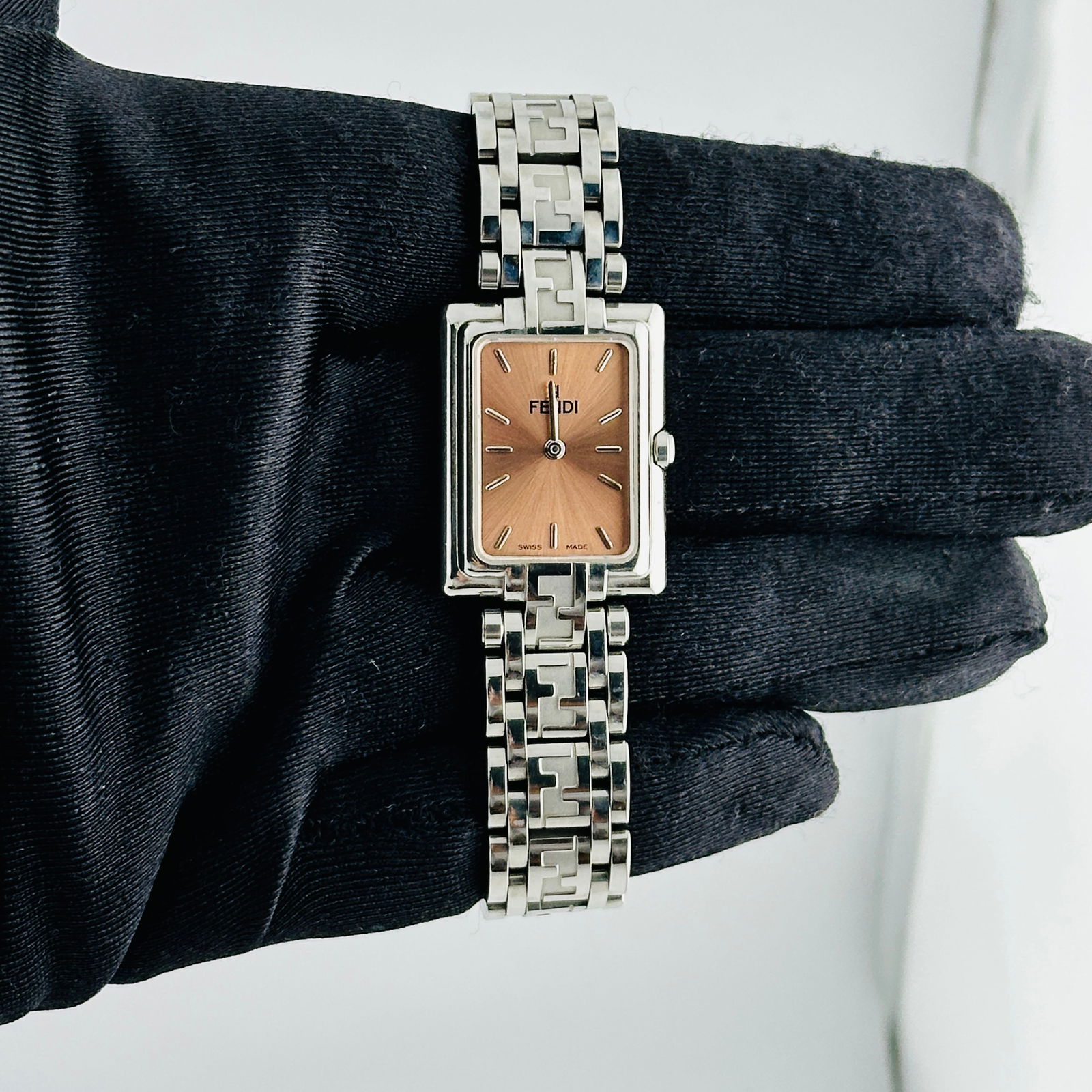 Fendi Ref 710L Stainless Steel 22mm Watch with Salmon Face: Fendi Ref 710L Stainless Steel 22mm Watch with Salmon Face This Fendi Orologi wristwatch features a salmon-colored dial and stainless steel case. The watch measures 22mm and includes 16 links. It is i