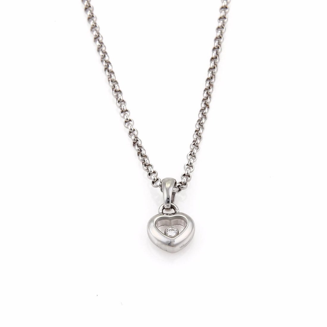 Chopard Happy Diamond 18k White Gold Mini Heart Pendant with Chain: Chopard Happy Diamond 18k White Gold Mini Heart Pendant with Chain This exquisite heart pendant and chain from the Chopard Happy Diamond Collection is a timeless piece crafted in 18k white gold. The p