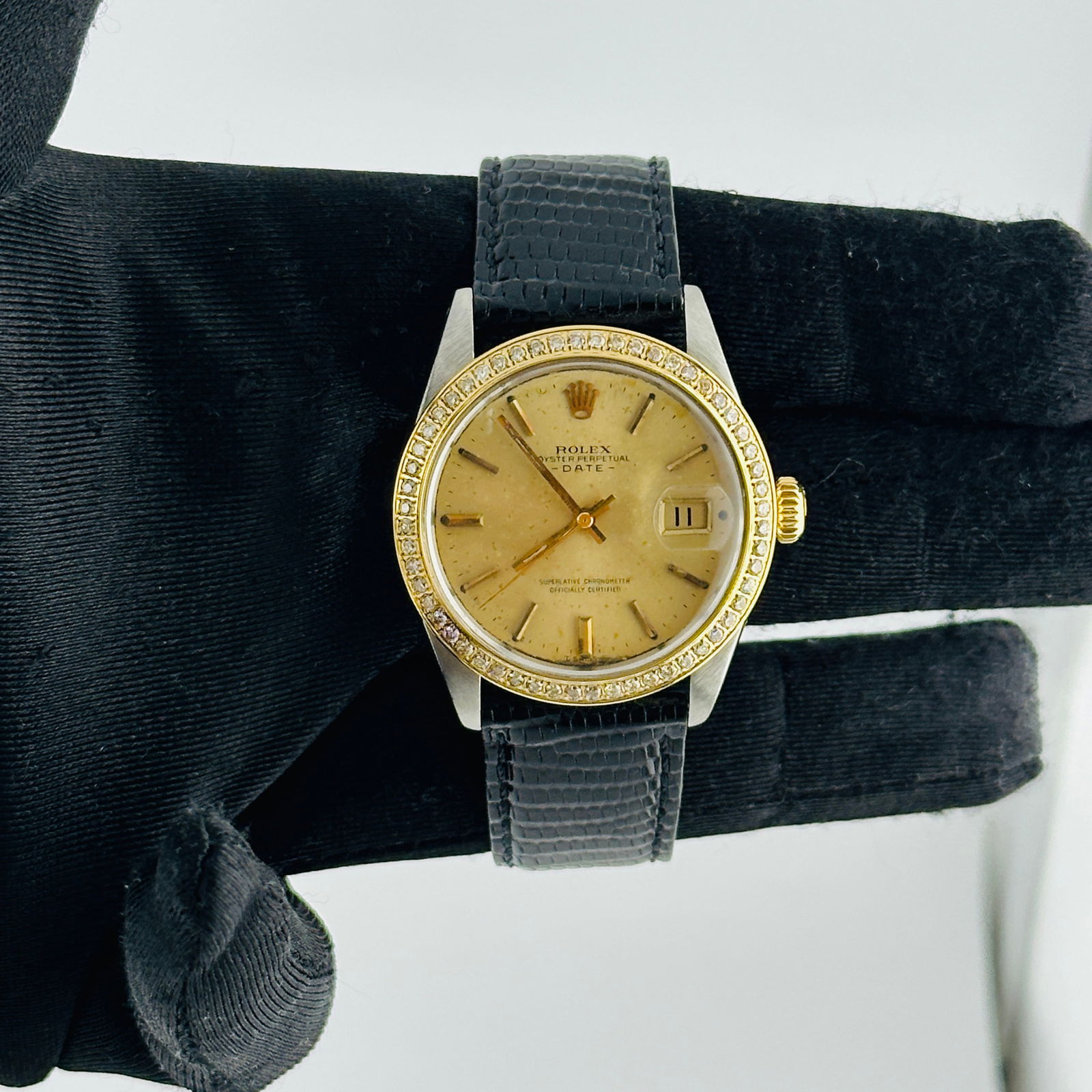 Oyster Perpetual Date Ref 1505 Gold Dial with Aftermarket Leather Strap: Oyster Perpetual Date Ref 1505 Gold Dial with Aftermarket Leather Strap This Rolex Oyster Perpetual Date features a distinctive gold dial and is equipped with an aftermarket leather bracelet. The time