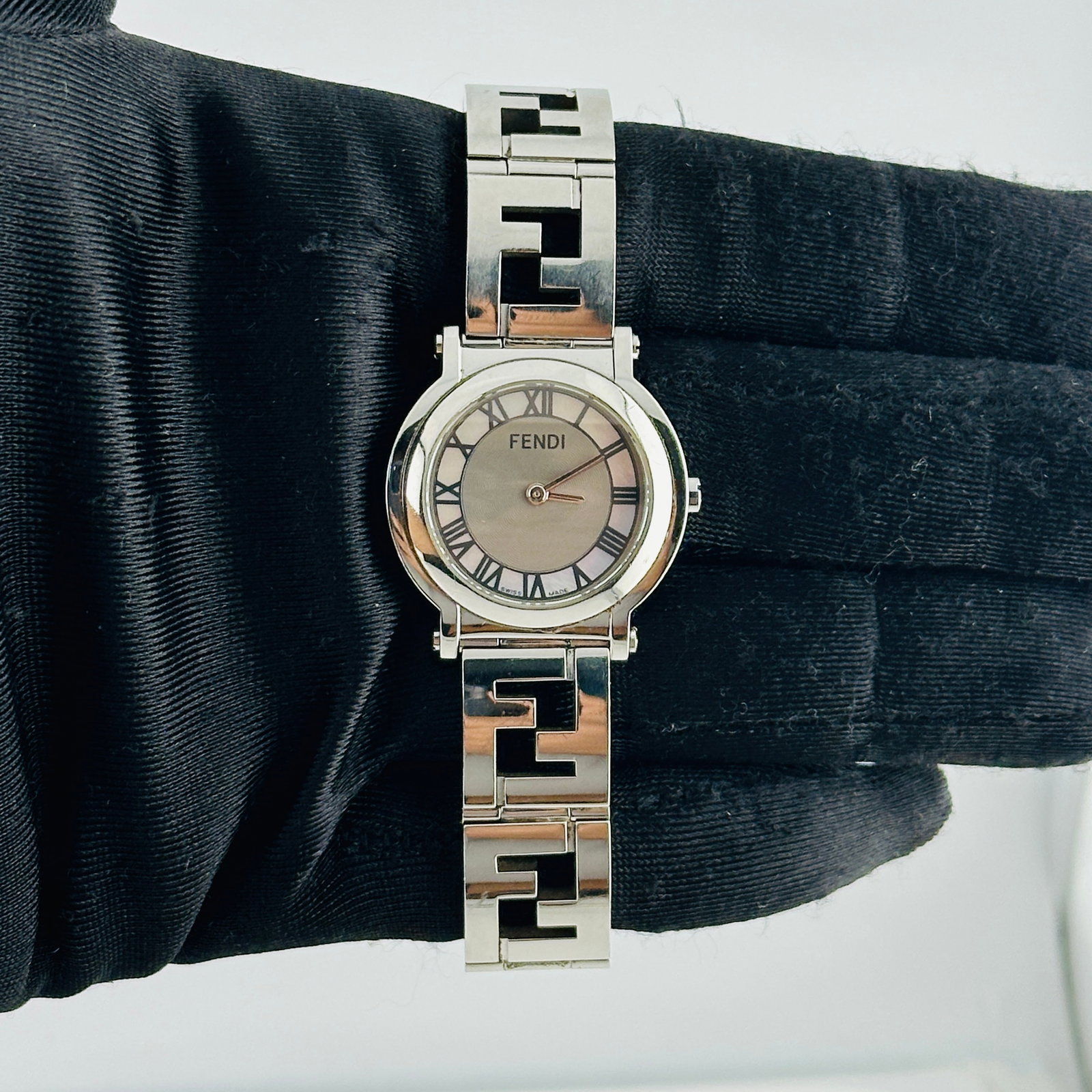 Fendi Ref 6100L Stainless Steel Watch with 2013 Card: Fendi Ref 6100L Stainless Steel Watch with 2013 Card This Fendi Orologi Mop Roman Dial Ref 6100L features a stainless steel case with a mother of pearl Roman numeral dial. The watch comes with its ori