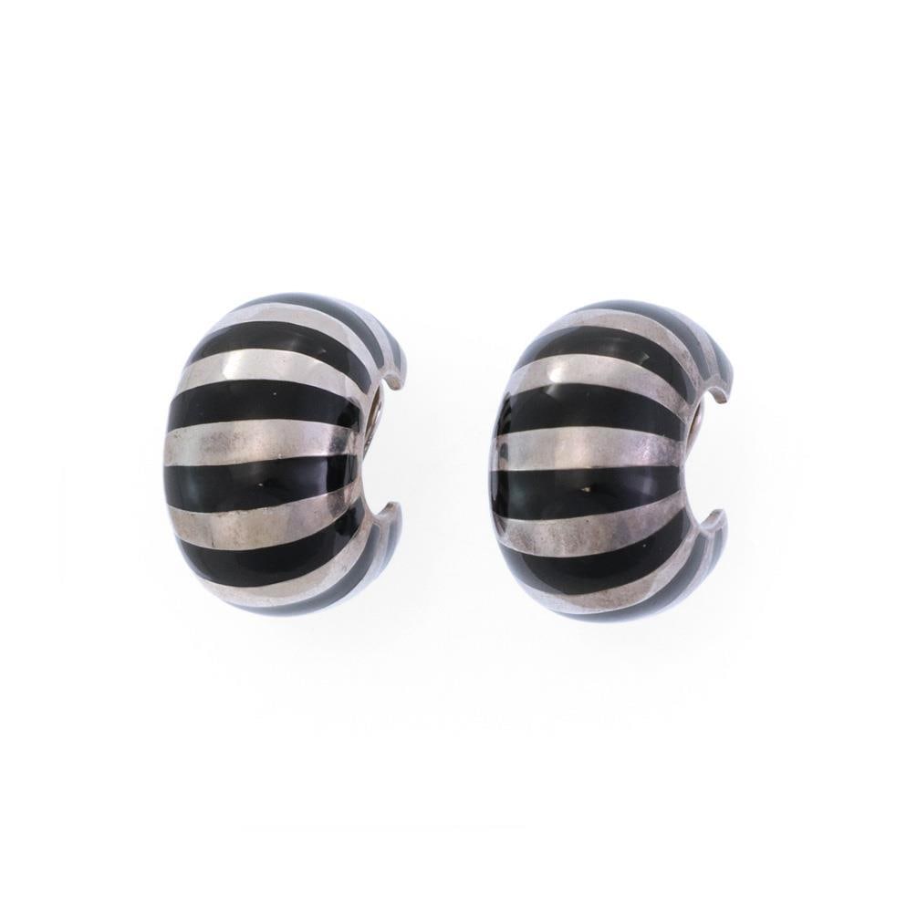Tiffany & Co. Sterling Silver Enamel Huggie Clip-On Earrings: Tiffany & Co. Sterling Silver Enamel Huggie Clip-On Earrings Elevate your accessory game with this elegant pair of Tiffany & Co. Huggie Earrings. Expertly crafted from high-quality sterling silver, th