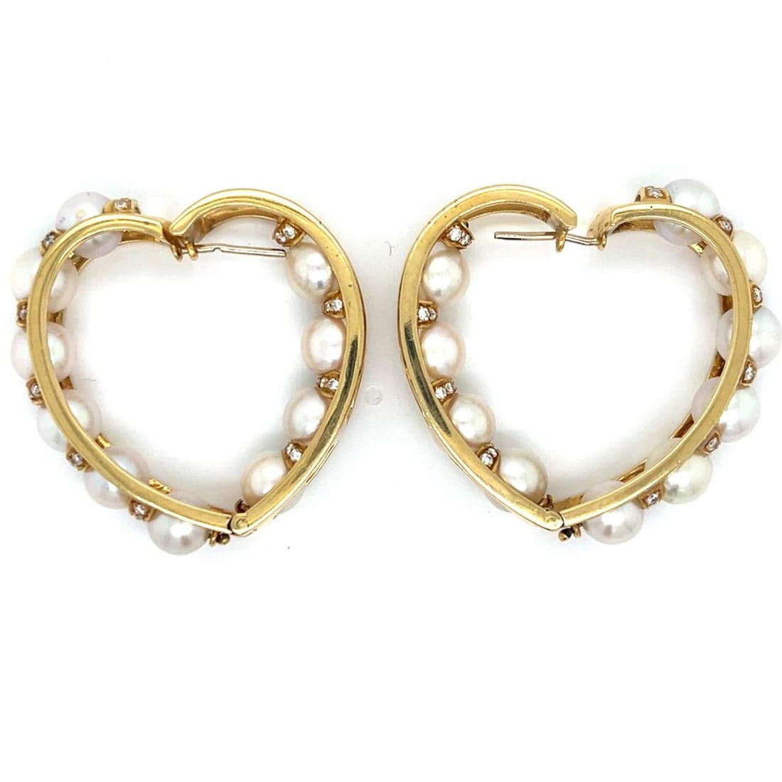 1970s 18K Yellow Gold Heart Hoop Earrings with 80 Diamonds: 1970s 18K Yellow Gold Heart Hoop Earrings with 80 Diamonds These stunning 1970's heart-shaped hoop earrings are crafted from 18K yellow gold and adorned with 80 diamonds, totaling approximately 1.00 C