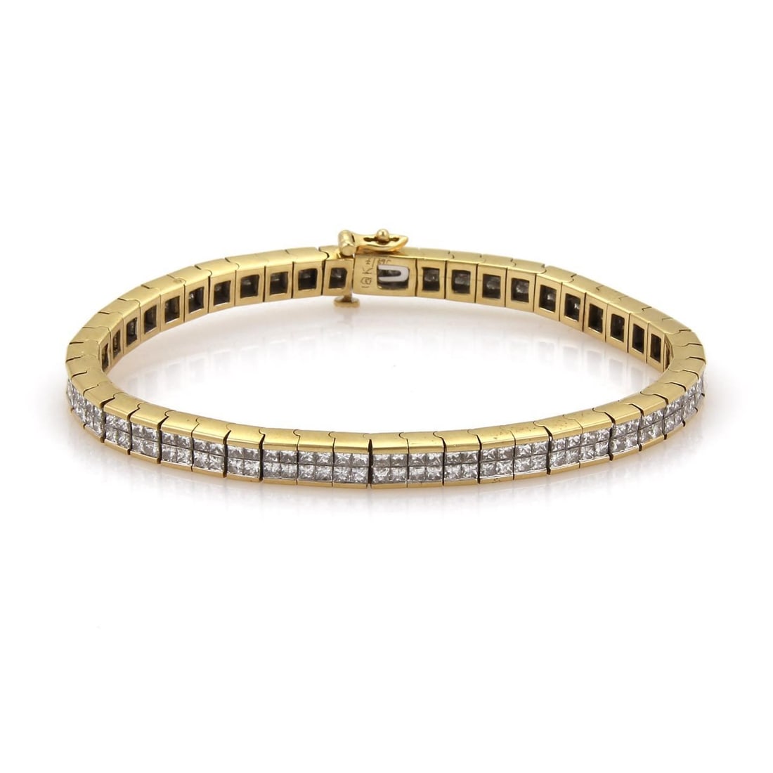 18k Yellow Gold 7 Carat Invisible Set Diamond Tennis Bracelet: 18k Yellow Gold 7 Carat Invisible Set Diamond Tennis Bracelet This exquisite tennis bracelet is expertly crafted from 18k yellow gold, featuring a sleek polished finish. Measuring 5mm in width, it sho