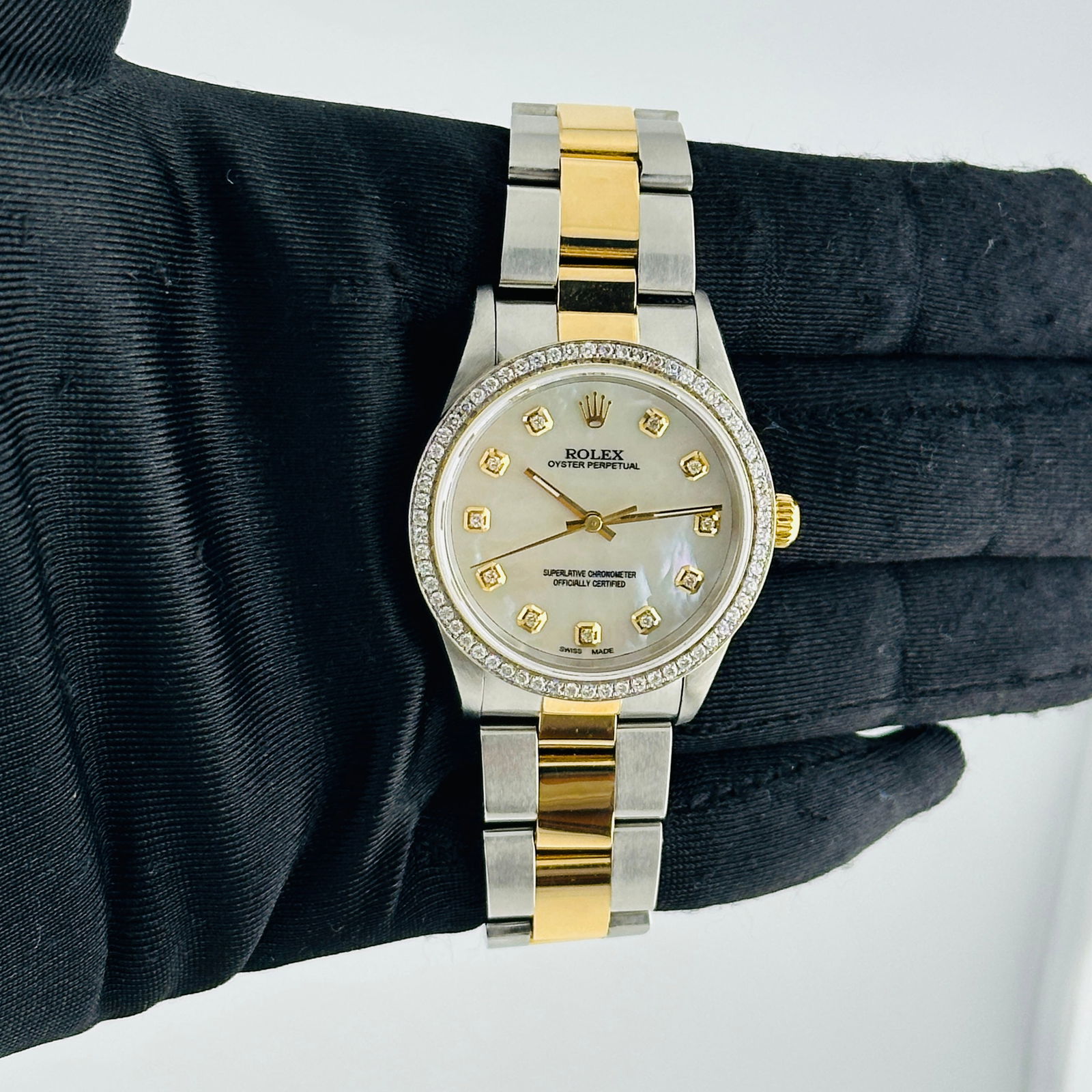 Oyster Perpetual Ref 14233 Unisex Watch Aftermarket White MOP Diamond Dial: Oyster Perpetual Ref 14233 Unisex Watch Aftermarket White MOP Diamond Dial This Rolex Oyster Perpetual features an after-market white mother-of-pearl diamond dial and a pave 10K diamond bezel. The wat