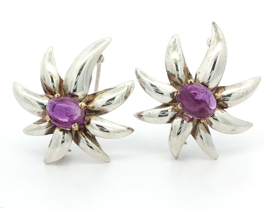 Tiffany & Co. 18k Gold Silver Amethyst Fireworks Brooch Pair: Tiffany & Co. 18k Gold Silver Amethyst Fireworks Brooch Pair This exquisite pair of brooches from Tiffany & Co. showcases two stunning natural amethysts, each in an oval cabochon cut and prong set. Th