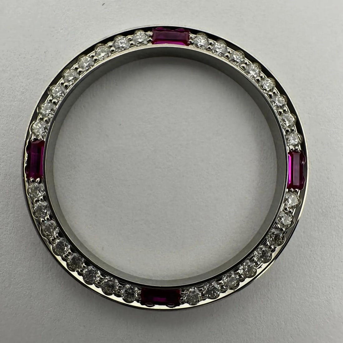 Custom Steel Bezel with .64ct Ruby Diamonds for Rolex Datejust: Custom Steel Bezel with .64ct Ruby Diamonds for Rolex Datejust Elevate your style with this exquisite Custom Steel Diamonds .64ct Ruby Bezel Datejust, designed to perfectly fit the Rolex Datejust mode