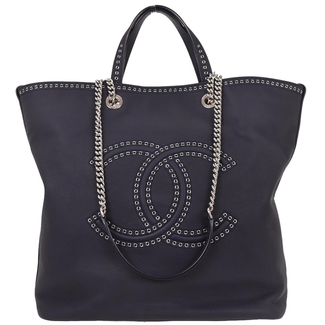 Large Navy Calfskin Tote with Coco Eyelets by Chanel: Large Navy Calfskin Tote with Coco Eyelets by Chanel This Chanel large shopping tote bag is crafted from navy leather and features eyelet details in the Coco style. The bag offers double handles, a ma