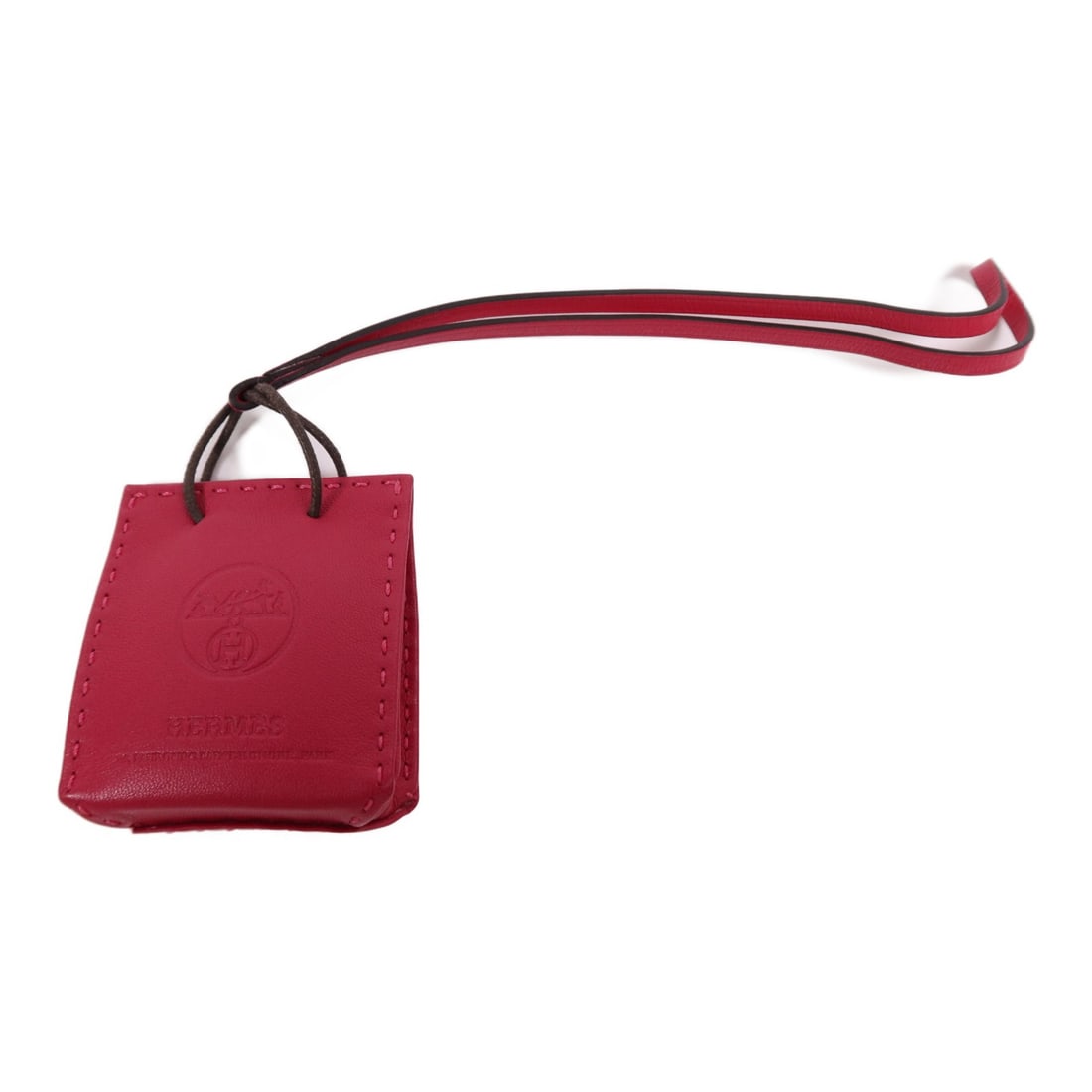 HERMES Milo Leather Charm Rosa Mexicano Lambskin Pink: HERMES Milo Leather Charm Rosa Mexicano Lambskin Pink This HERMES Paper Bag Charm is a stylish accessory crafted from premium lambskin (sheep leather) in a vibrant Rosa Mexicano pink color. Designed a