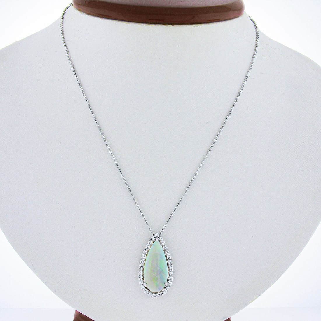 New 4.7ctw White Gold Opal Diamond Halo Teardrop Pendant Necklace: New 4.7ctw White Gold Opal Diamond Halo Teardrop Pendant Necklace This stunning pendant features a teardrop shape adorned with a pear-cut natural opal and a halo of 28 sparkling diamonds. Crafted from