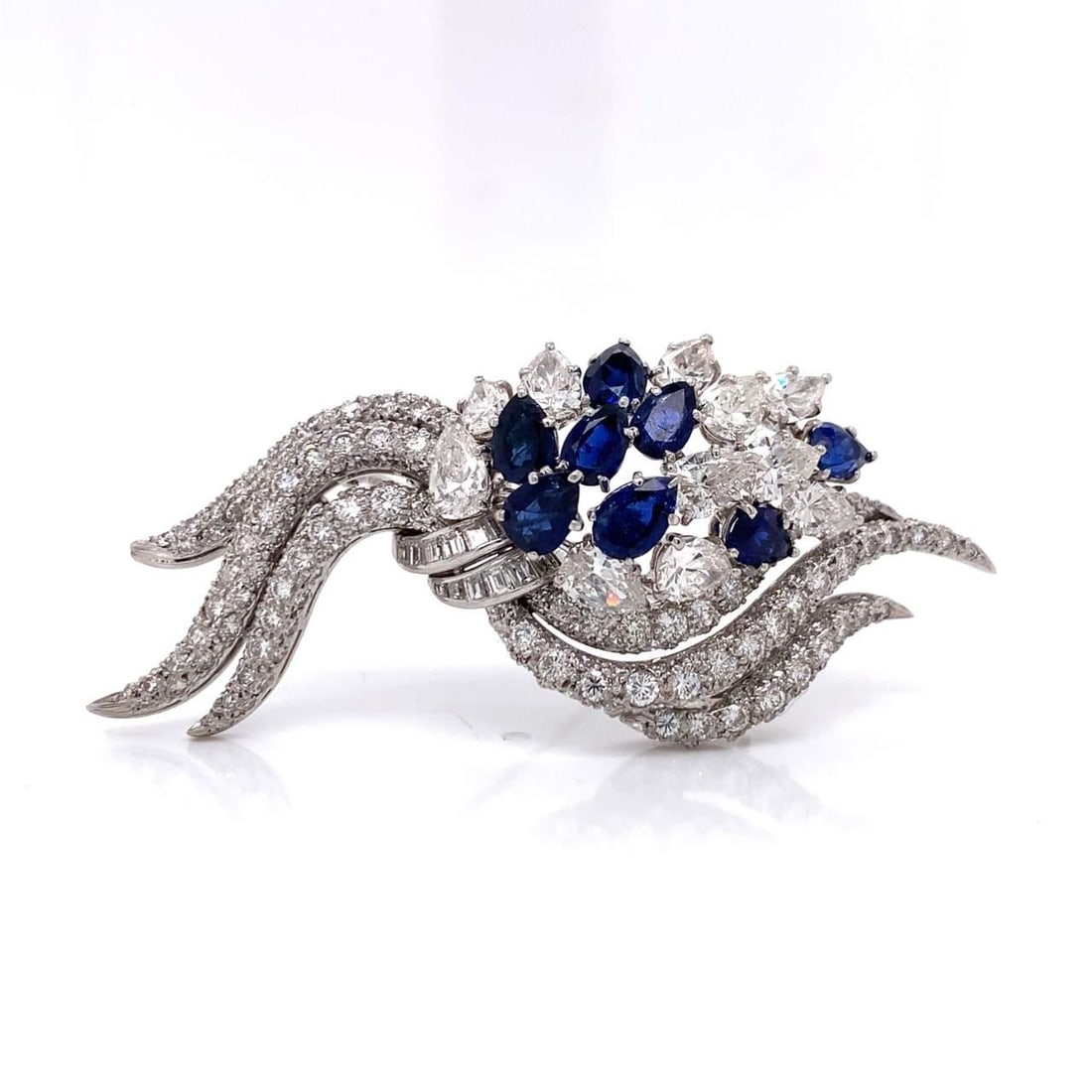 Art Deco Platinum Brooch 10 Ct Diamonds 3 Ct Sapphires: Art Deco Platinum Brooch 10 Ct Diamonds 3 Ct Sapphires This exquisite Art Deco brooch showcases a stunning combination of diamonds and sapphires set in platinum. The piece features 11 pear-shaped diam