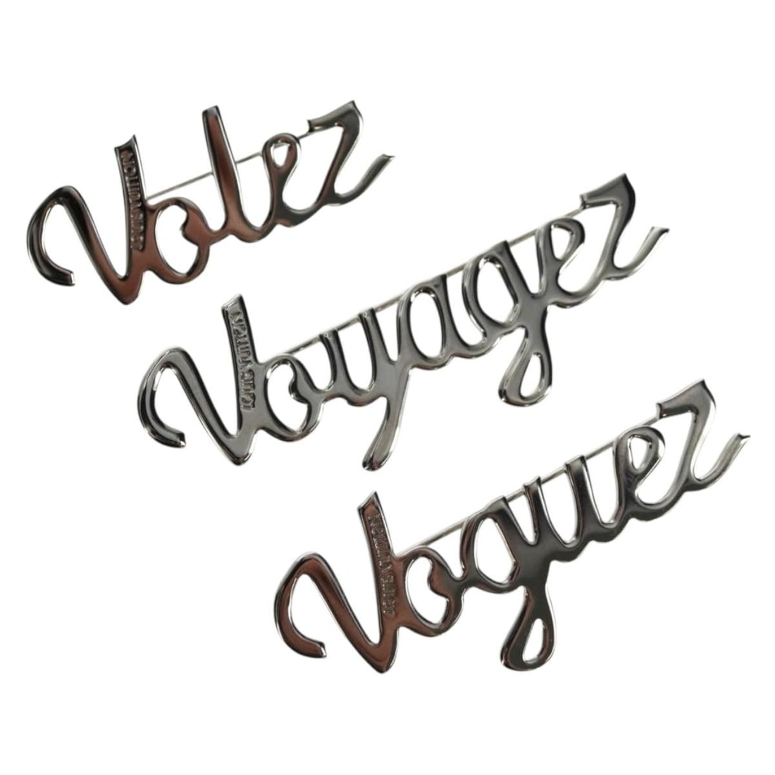 Louis Vuitton VolezVoguezVoyagez Silver Metal Brooch With Box M62507: Louis Vuitton VolezVoguezVoyagez Silver Metal Brooch With Box M62507 This Louis Vuitton VolezVoguezVoyagez brooch set features three silver-tone metal brooches, each with a unique design and size. Cra