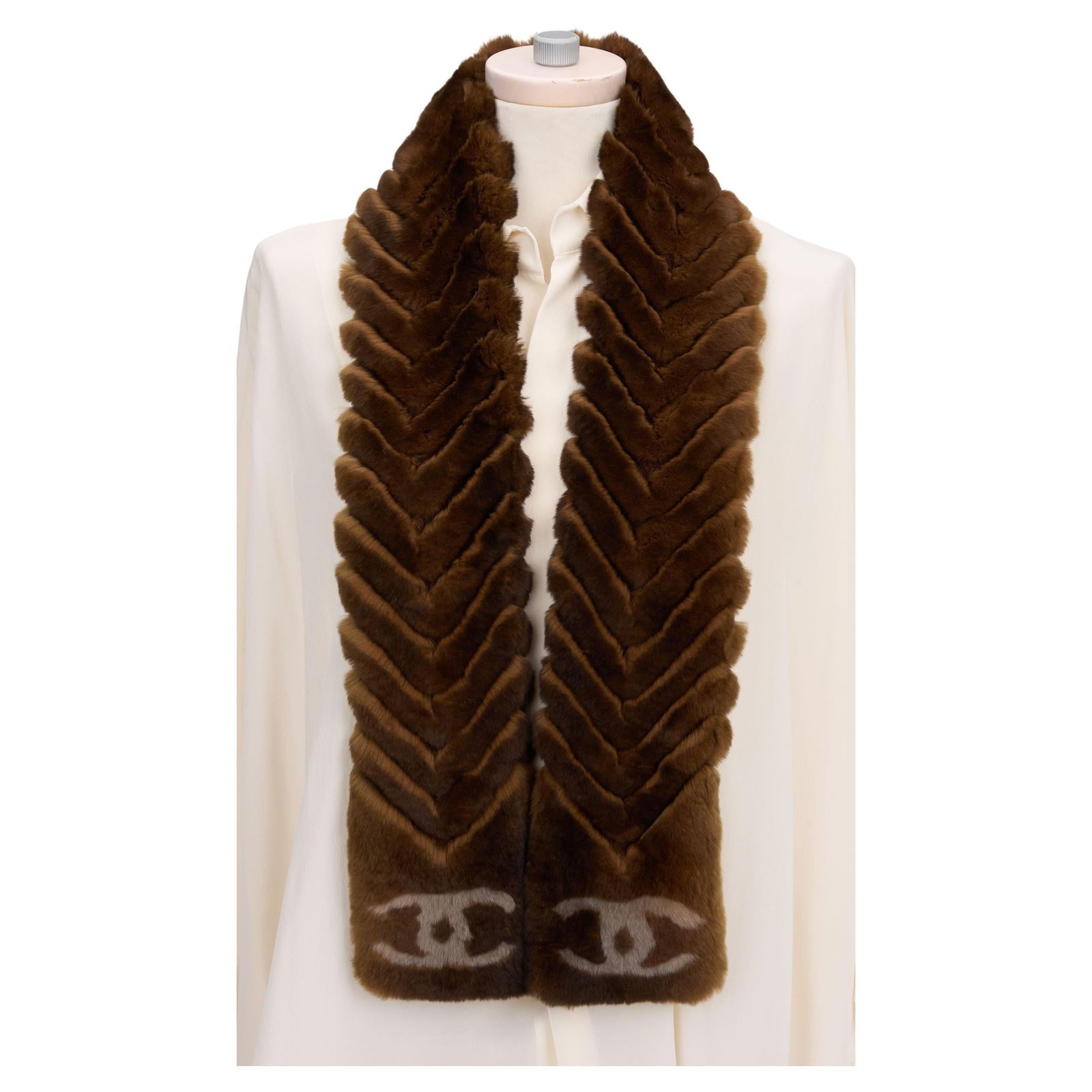 Chanel Brown Chinchilla Orylag Scarf with CC Logo: Chanel Brown Chinchilla Orylag Scarf with CC Logo Elevate your winter wardrobe with this exquisite Chanel Chinchilla Orylag scarf. Crafted in Italy, this luxurious scarf boasts a beautiful brown hue a