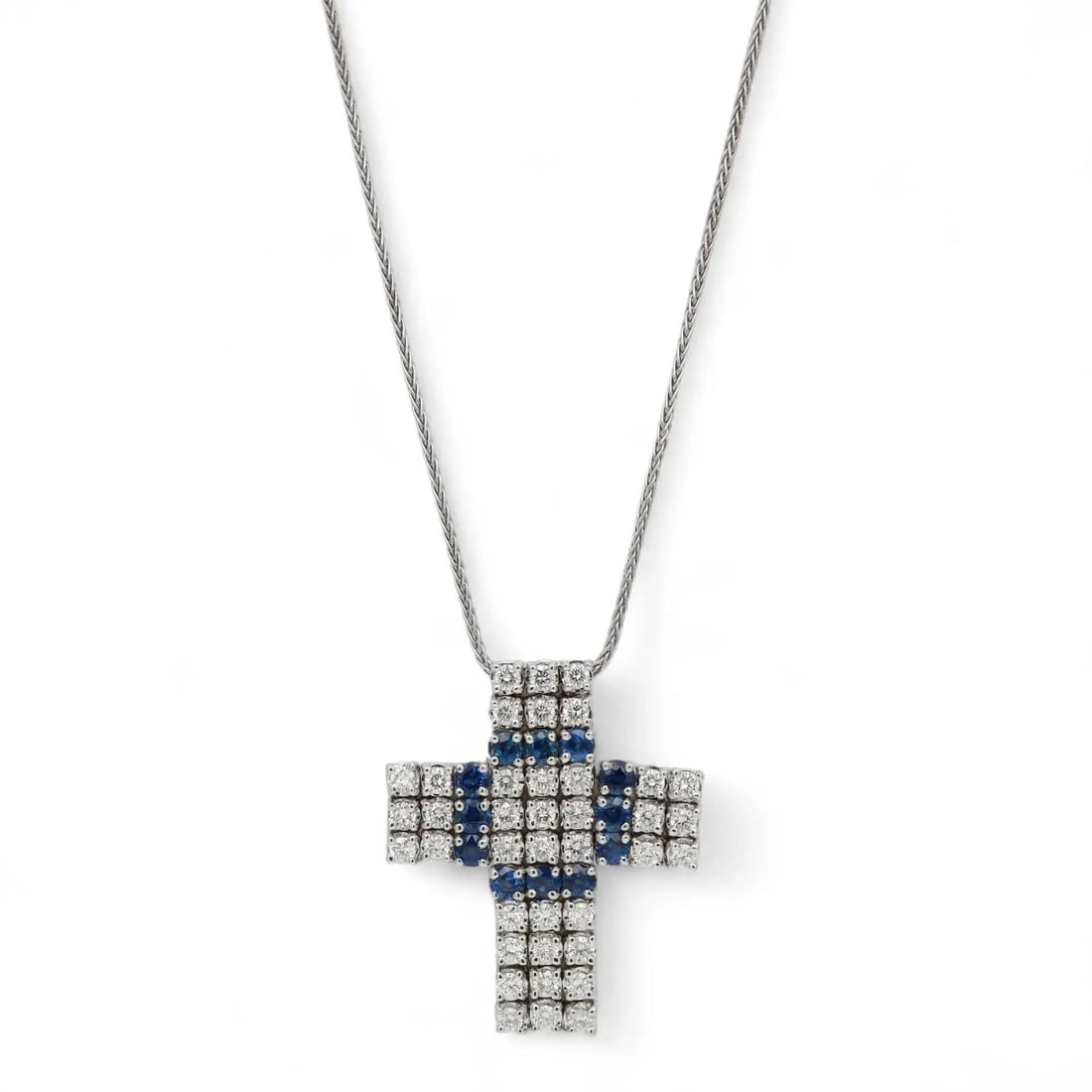 Damiani 18K White Gold Cross Pendant Necklace with Diamonds and Sapphires: Damiani 18K White Gold Cross Pendant Necklace with Diamonds and Sapphires This exquisite Damiani cross pendant necklace is a true embodiment of luxury, crafted from 18K white gold. The pendant feature